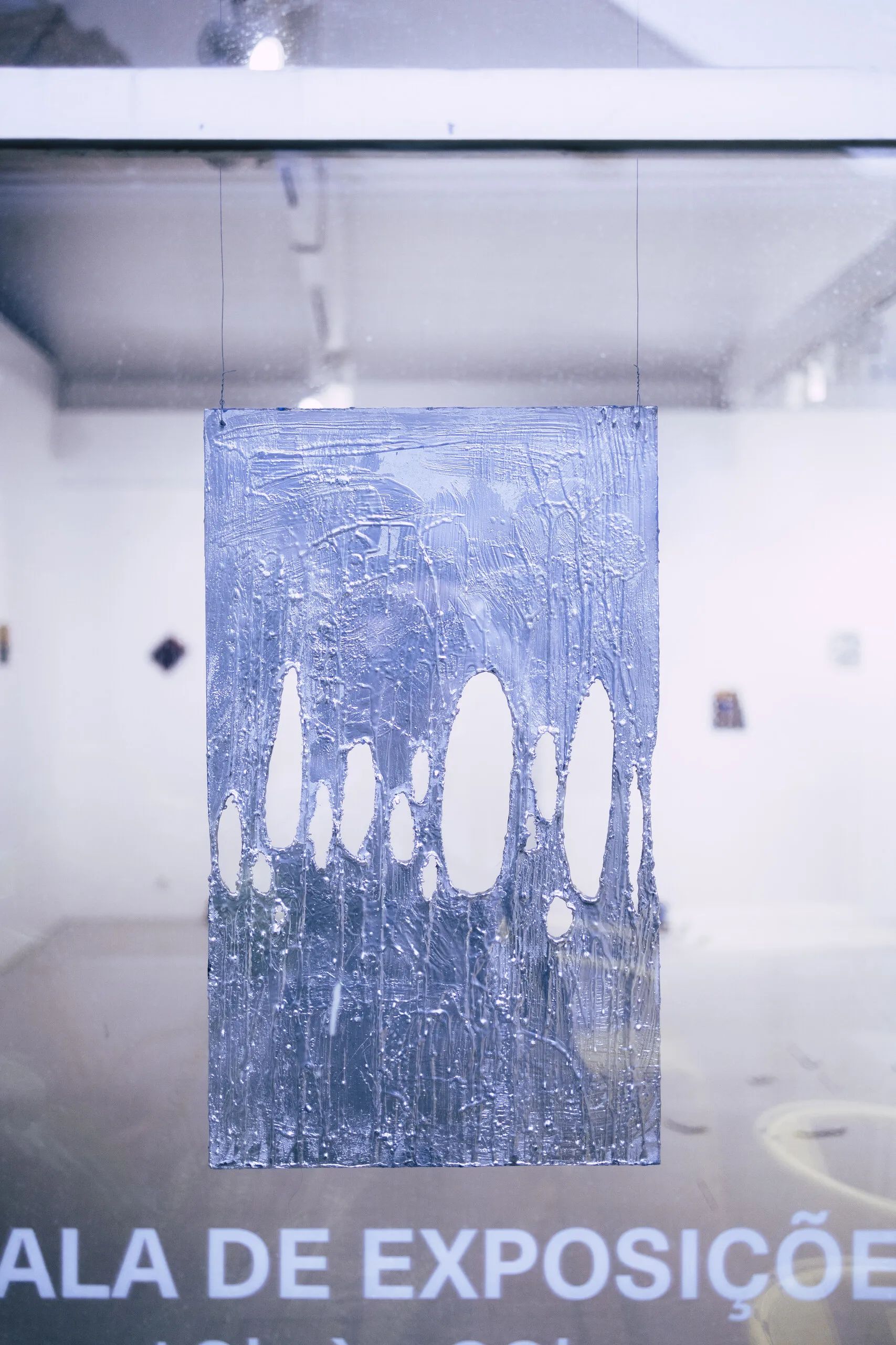 Espelho Meu, installation view: large suspended blue print with cut-out shapes. Photo: Jenniffer Lima Pais
